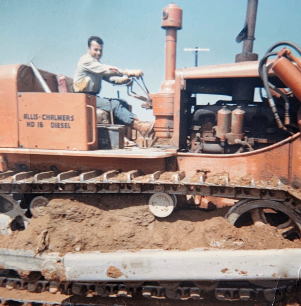 Photo of Buddy MacEachern on top of a dozer.  