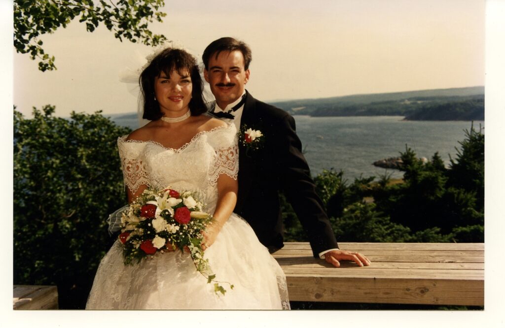 Bride and Groom sitting at lookout over Ballantynes Cove